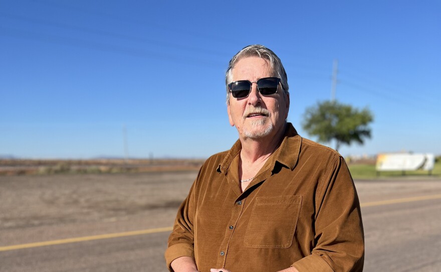 Winslow Chamber of Commerce CEO Bob Hall stands next to the rumble strips the chamber had installed on Route 66.
