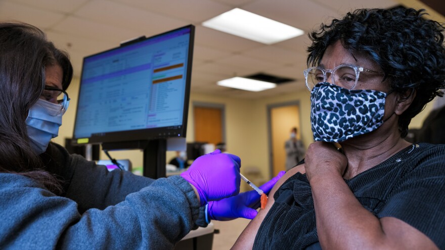 A woman receives the Moderna COVID-19 vaccine at the Bates Memorial Baptist Church in Louisville, Ky., on Feb. 12. Yet in many states, there are racial disparities in who has received the shot.