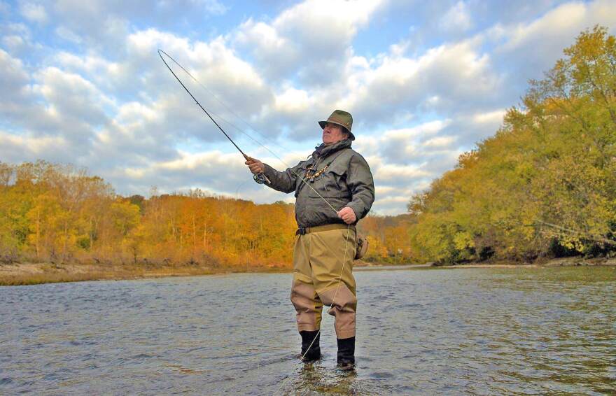 Former water conservationist Tim Guilfoile fishes in the Little Miami River.