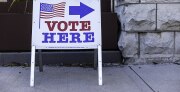 Sign reads Vote Here. 