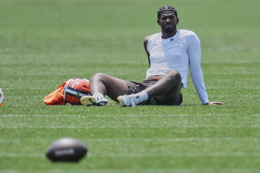 Cleveland Browns quarterback Shedeur Sanders (12) sits on the field after practice at NFL football minicamp in Berea, Ohio, Wednesday, June 11, 2025.