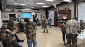 A group of hunters, all dressed in camouflage, waits in a Missouri Department of Conservation office to hear if they've been granted access to hunt ducks.