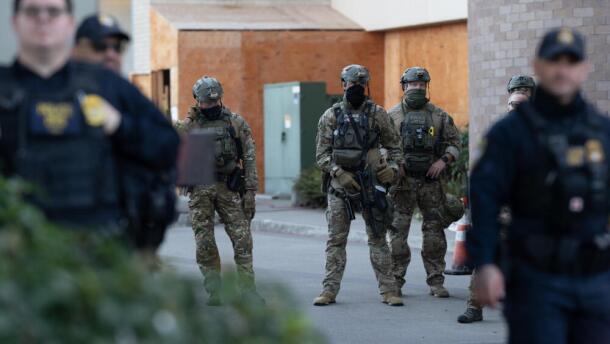 Law enforcement officers look out from a United States Immigration and Customs Enforcement (ICE) facility Oct. 21, 2025, in Portland, Ore. (Jenny Kane/AP)