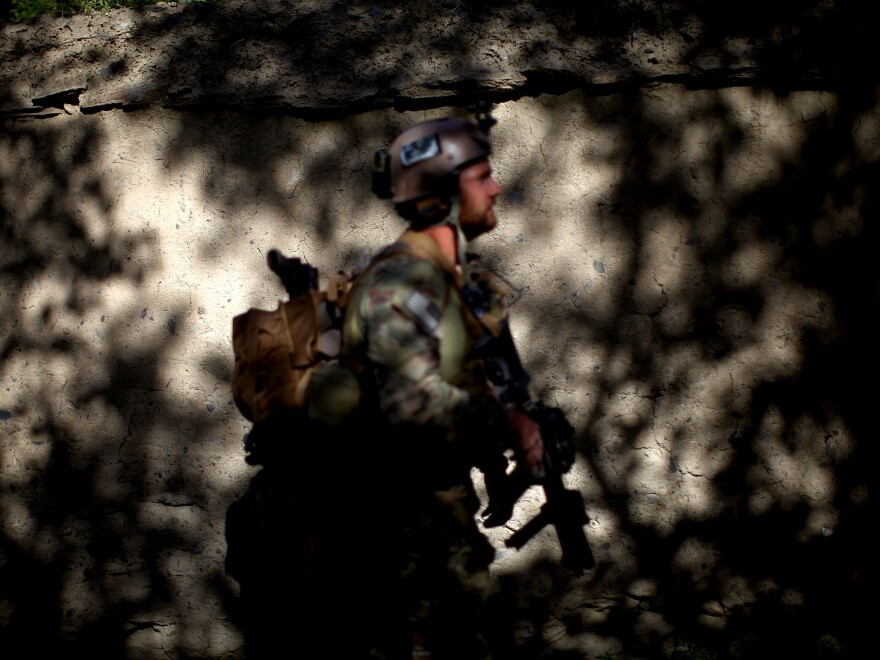U.S. Green Berets patrol with Afghan National Army special forces outside the village of Kasan, in Wardak province. The Green Berets along with the ANASF have been training Afghan local police to take the lead in their village stability and security.