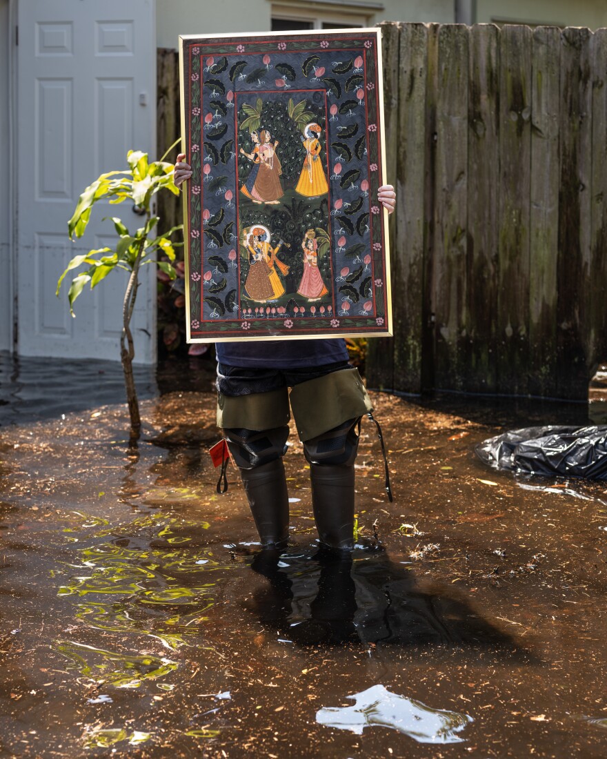 Jody Berman holds up one of the only possessions she was able to salvage from the flooding: A family heirloom Indian painting that belonged to her grandmother. "Everything, like literally everything is destroyed in my house," she said.