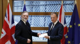 Britain's permanent representative to the European Union Tim Barrow, left, hands British Prime Minister Theresa May's Brexit letter in notice of the UK's intention to leave the bloc under Article 50 to EU Council President Donald Tusk on March 29, 2017. (Yves Herman/Pool Photo via AP)