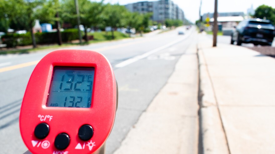 An infrared sensor measures surface temperature on North Davidson Street in NoDa.