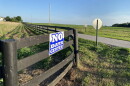 An anti-data center sign is across the street from farmland where a massive hyperscale data center has been proposed in rural Mercer County.