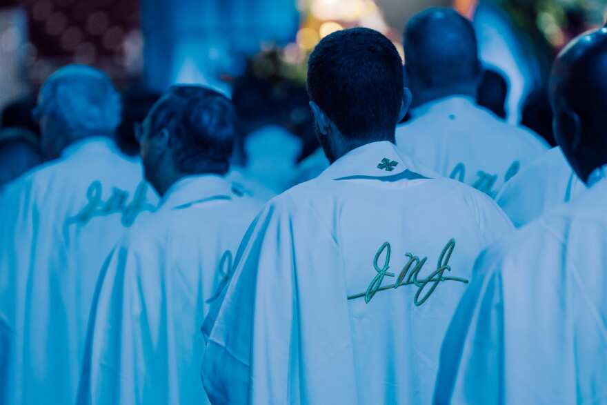 Clergy wear vestments embroidered with "JMJ," an abbreviation for Jesus, Mary and Joseph, during the beatification Mass for the late Archbishop Fulton J. Sheen on Thursday at the Dome at America's Center in downtown St. Louis. The initials reflect Sheen's devotion to the Holy Family; a prayer he promoted begins, "Jesus, Mary, Joseph, I love you very much."