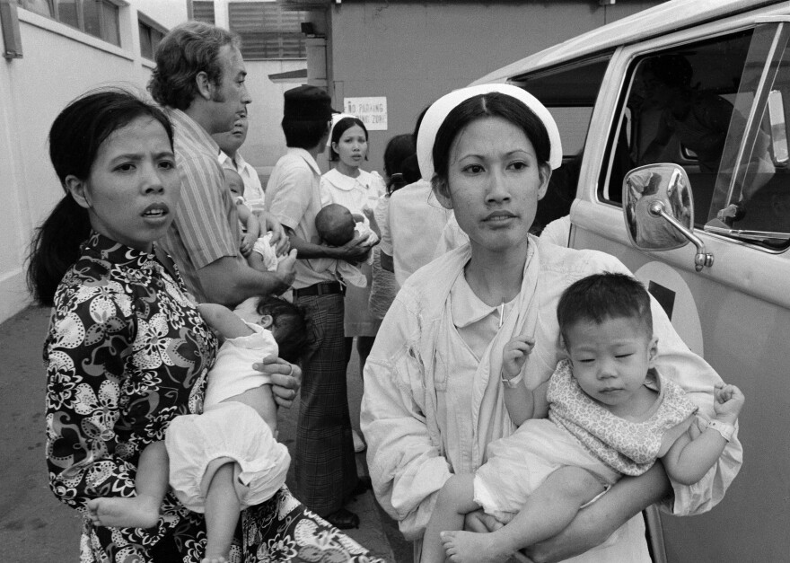 South Vietnamese infants are carried by nurses after arrival at Saigon hospital, April 4, 1975. Children were on C5A that crashed. (AP Photo/Neal Ulevich)