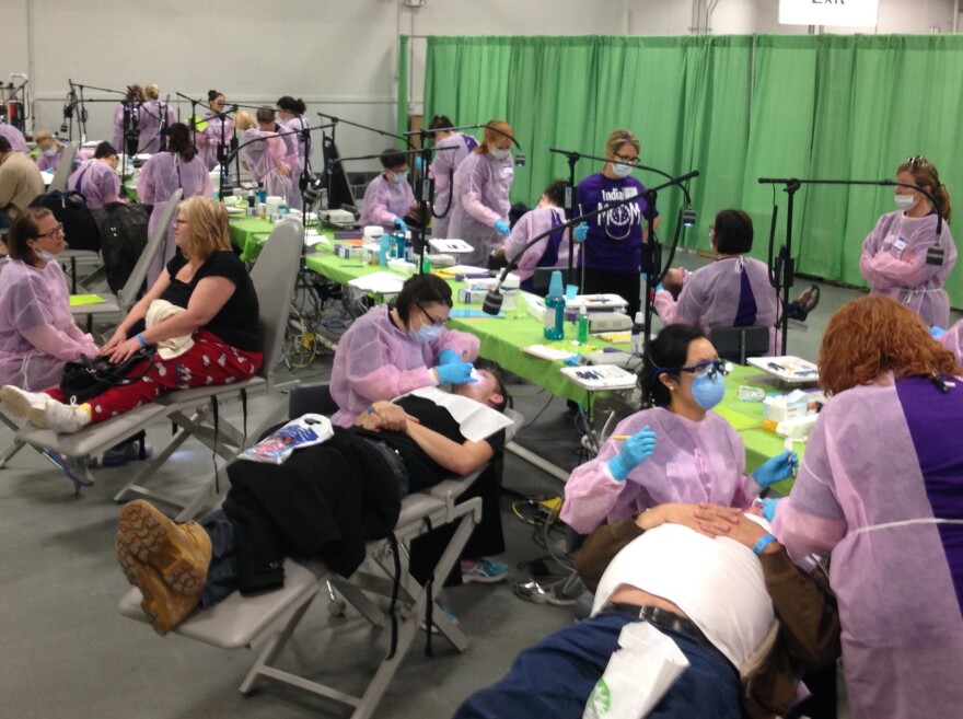 Dentists see patients at a free dental care event sponsored by the Indiana Dental Association. More than 1200 people attended, many of whom hadn't seen a dentist in years.