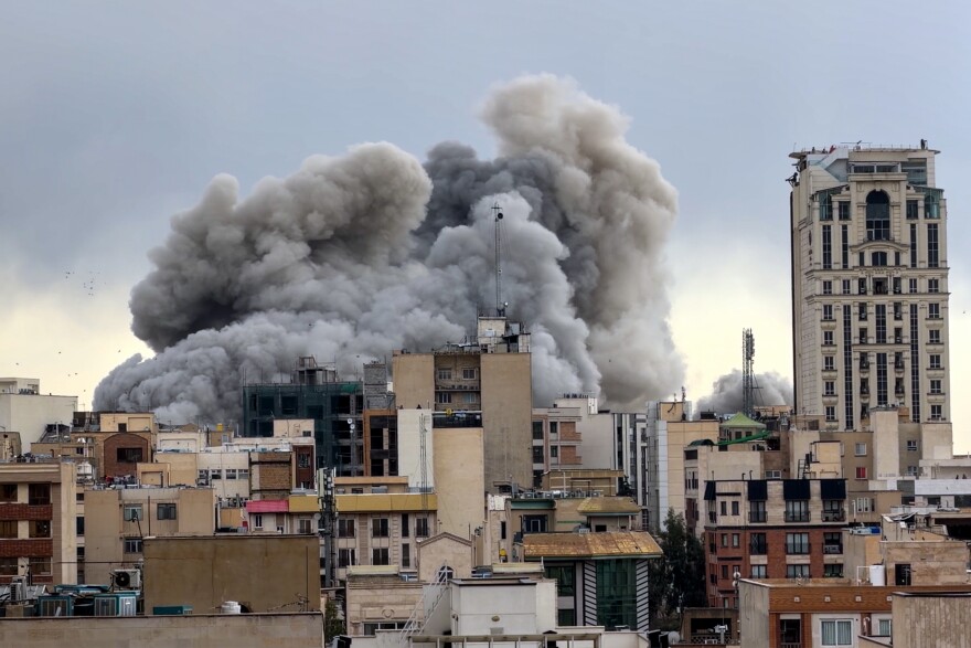 A plume of smoke rises after a strike in Tehran, Iran, Monday, March 2, 2026.