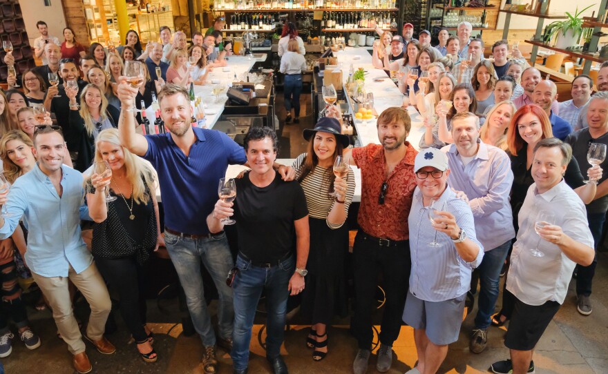 Record executives, musicians and more at Barcelona Wine Bar in the Edgeville neighborhood of Nashville. Center, Scott Borchetta, founder of Big Machine Records, with the members of <a href="https://www.npr.org/sections/live-updates-protests-for-racial-justice/2020/07/09/889355126/lady-a-the-band-sues-lady-a-the-singer">Lady Antebellum</a>.