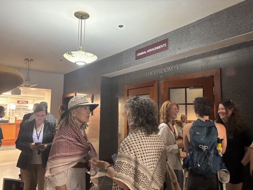 Protesters waiting outside the courtroom for their arraignment on July 24, 2025.
