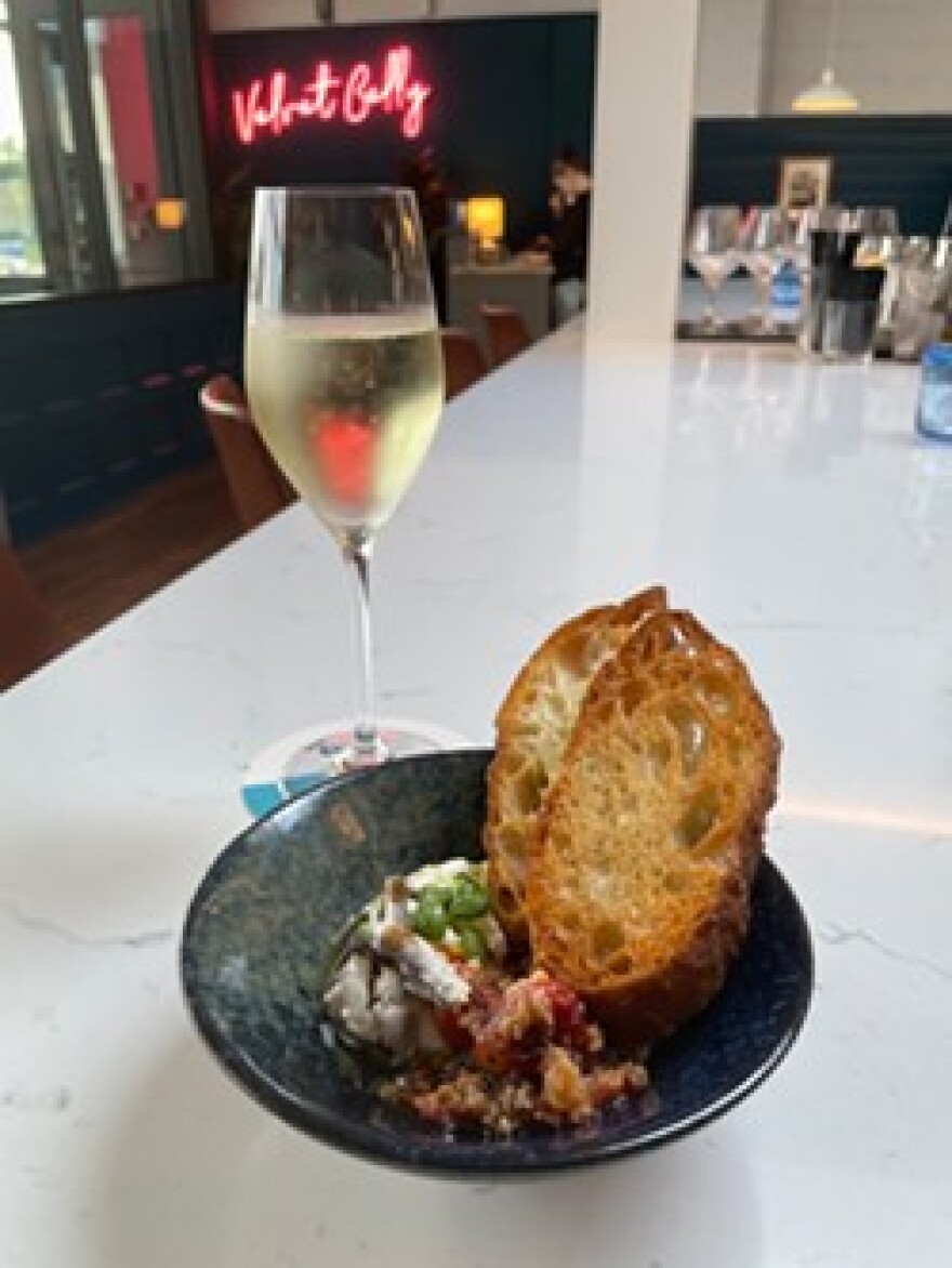 Velvet Belly's House-made Ricotta, which is served with roasted cherry tomato ‘pappa al pomodoro,’ marinated Spanish anchovies, and crostini.