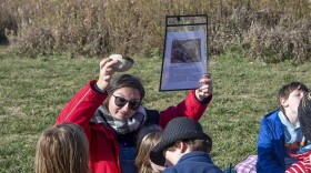 Natalie Brown, teacher at Bluestem Hall Nature School in Urbana, Illinois is pictured with children near prairie plantings during an outdoor class on October 30, 2025.