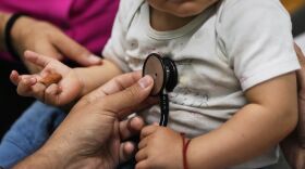 A doctor's hand examines a 16-month-old boy 