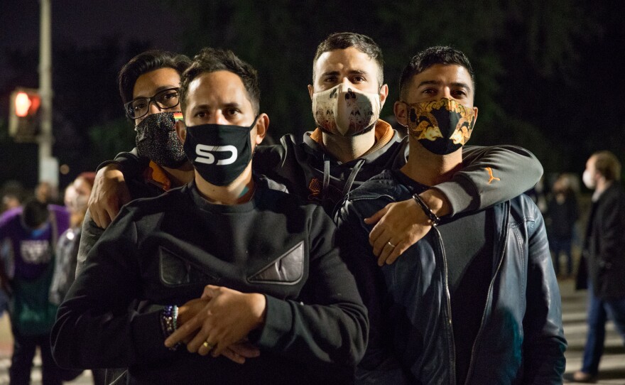 (Left to right) Kelvin Flores, Franklin Ortiz, Steven Zatarga and Shahab Albahar listen to speakers in front of the U.S. Supreme Court during the vigil.
