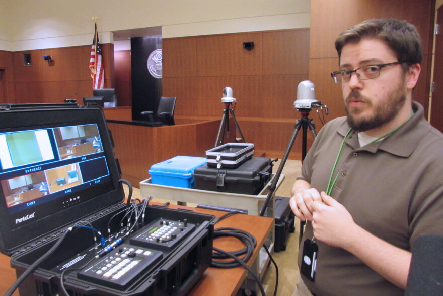 Courtroom technology administrator Jeremy Sites explains the camera setup in U.S. District Court.