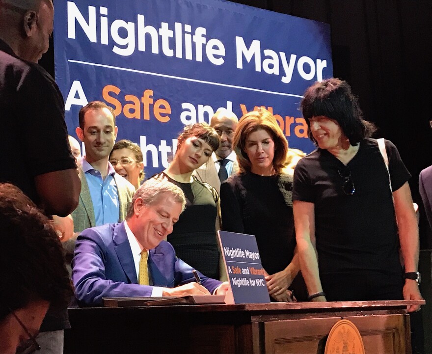 New York City Mayor Bill de Blasio signs a bill establishing the Office of Nightlife at the House of Yes in Bushwick, Brooklyn. Right, Marky Ramone.