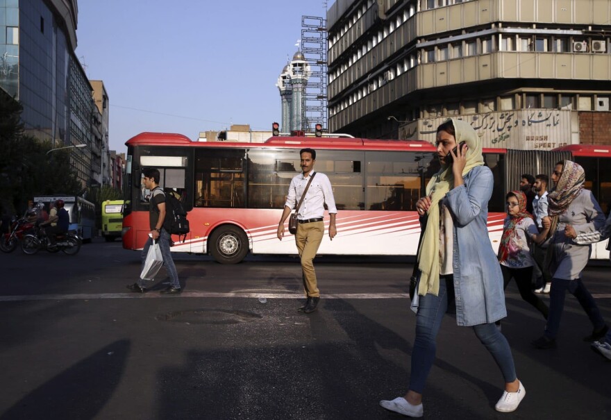 People cross Jomhouri-e-Eslami (Islamic Republic) St. in downtown Tehran, Iran, Monday, July 30, 2018. Iran's currency plummeted to a record low Monday, a week before the United States restores sanctions lifted under the unraveling nuclear deal, giving rise to fears of prolonged economic suffering and further civil unrest. (Vahid Salemi/AP)