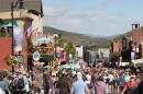 Crowds walk down Park City Main Street after the 2026 Miners Day Parade.