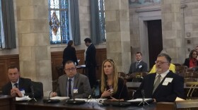 Manufacturing company executives testify at legislative hearing.