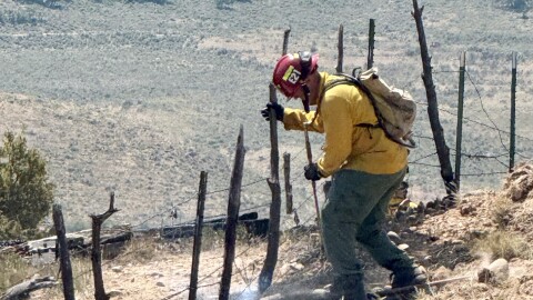 A North Summit firefighter works on a small brush fire that ignited near the southern end of Coalville's Main Street June 27, 2025.