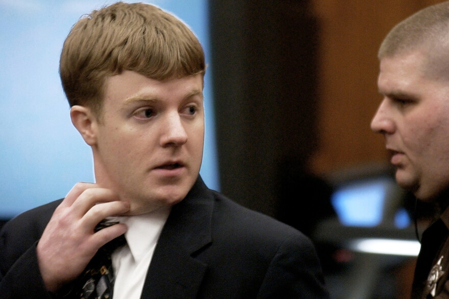 Justin Michael Wolfe, left, looks back towards his parents as he is led from the courtroom by a sheriff's deputy after being found guilty of capital murder in Manassas, Va., Jan. 22, 2002.