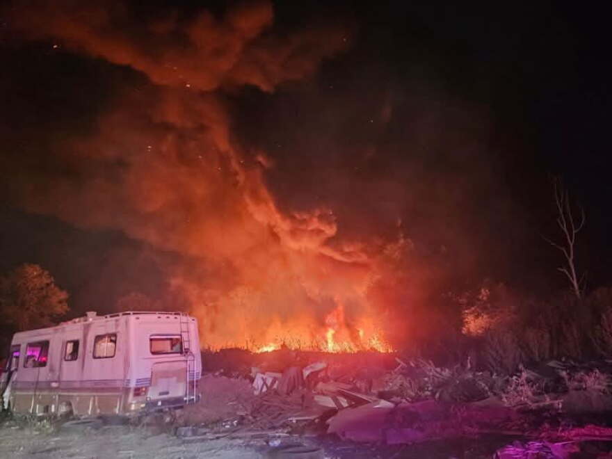 Firefighters from multiple counties and cities worked throughout the night Sunday to contain a 10-acre fire in Sand Branch.