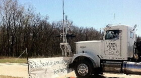 A tractor trailer rig slams into the barricade