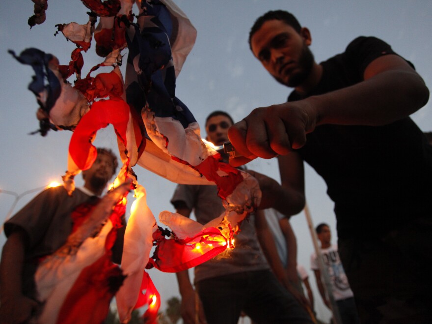 Libyan followers of the Ansar al-Sharia militant group burn the U.S. flag during a protest in Benghazi, Libya, on Sept. 14.