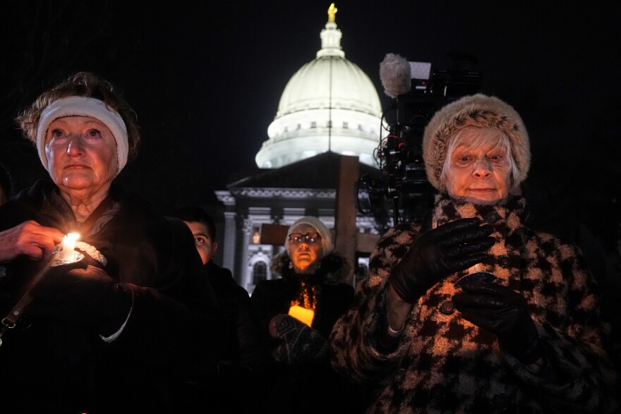 Supporters hold candles during a candlelight vigil Tuesday, Dec. 17, 2024, outside the Wisconsin Capitol in Madison, Wis., following a shooting at the Abundant Life Christian School on Monday, Dec. 16.