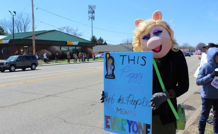 Jenn Shimon dresses as Miss Piggy at the Peoria "No Kings" protest with a sign