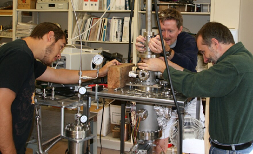 Matt Bovyn, left, NAU physics major and NASA Spacegrant intern, Stephen Tegler, center, professor of physics and astronomy and Will Grundy an astronomer from Lowell Observatory work with the ice chamber in the lab.