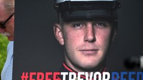 Joey Reed, the father of former US Marine Trevor Reed, stands next to a placard of his son during a press conference outside the U.S. Capitol in Washington, D.C., on July 29, 2021.