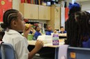 Children eat breakfast on the first day of school in New Orleans on Aug. 4, 2025.