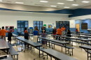 Community members talk in the Oakcrest Elementary cafeteria after a meeting about the proposed Wyomina Park rezoning. Many of those in attendance were Oakcrest staff members and parents with their children.