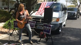 Steven Boz performs outside of a Trump campaign office. He says he loves Trump's "attitude."