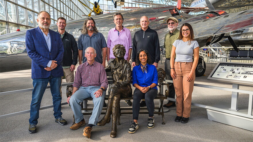 Purdue University and Archaeological Legacy Institute (ALI) members of the Amelia Earhart expedition team traveling to Nikumaroro Island visited The Museum of Flight in Seattle to view a replica of a Lockheed Electra 10-E, the type of plane Earhart was piloting in her bid to fly around the world. Seated next to a statue of Earhart are Richard Pettigrew, ALI executive director, left, and Sirisha Bandla, field assistant and Purdue alumna. Back row, from left, are Ren LaRocca, ALI assistant; Aaron Arrants, medic; Michael Krivor, RECON Offshore maritime archaeologist; Helmut Schleppi, filmmaker; Steve Schultz, field assistant and Purdue senior vice president and general counsel; Tom Reitter, ALI filmmaker; and Ella Van Cleave, filmmaker. (Purdue University photo/Becky Robiños)