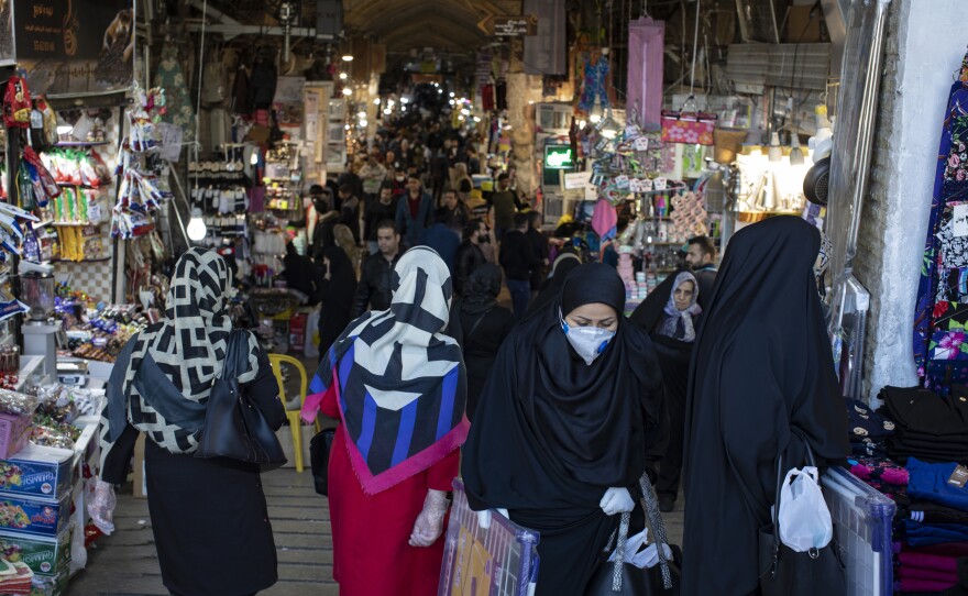 Ahead of the Iranian new year, Tehran's Grand Bazaar is relatively empty as costumers stay away amid fears of being infected with the coronavirus. Others take precautions by wearing gloves and masks.