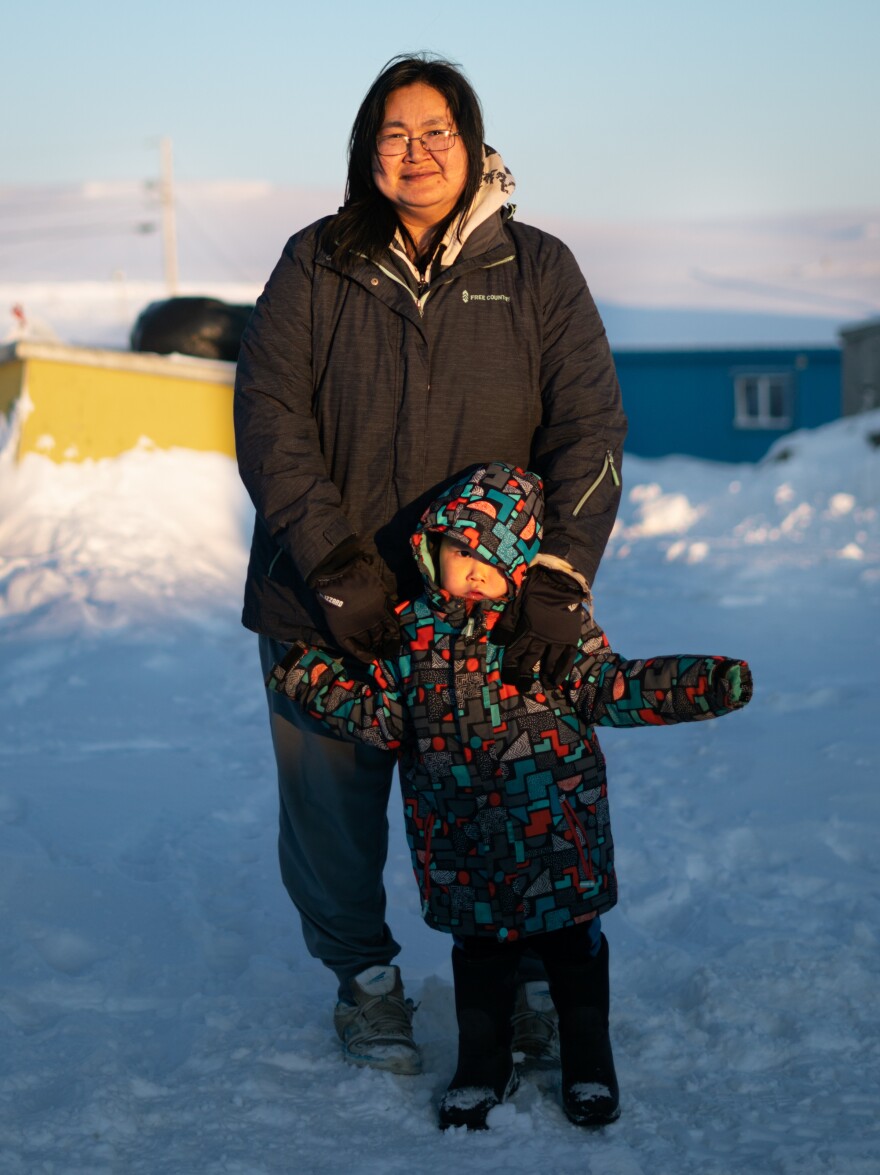 Maria White and her son Lance Jimmie, 3, stand near their home in Toksook Bay. White works at Bayview General Merchandise, one of the three convenience stores in Toksook Bay.