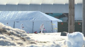 Workers heading into a Rose Acres egg layer facility after an avian influenza outbreak.