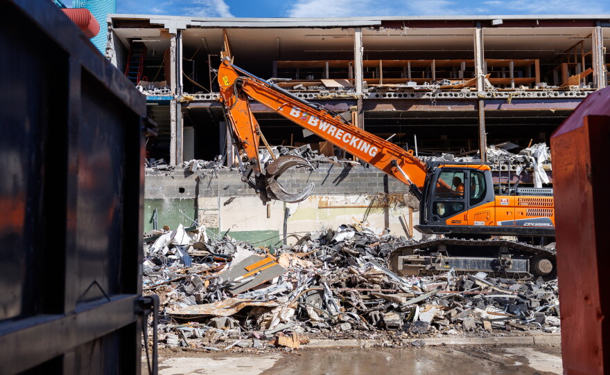 Demolition crews tear down the former Spartan Bookstore in East Lansing, Mich., on Sept. 14, 2026. A new apartment high-rise will be built on the site.