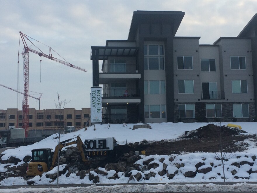 Photo of apartments under construction in snow.