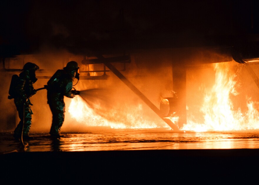 Firefighters use hose to tame large fire