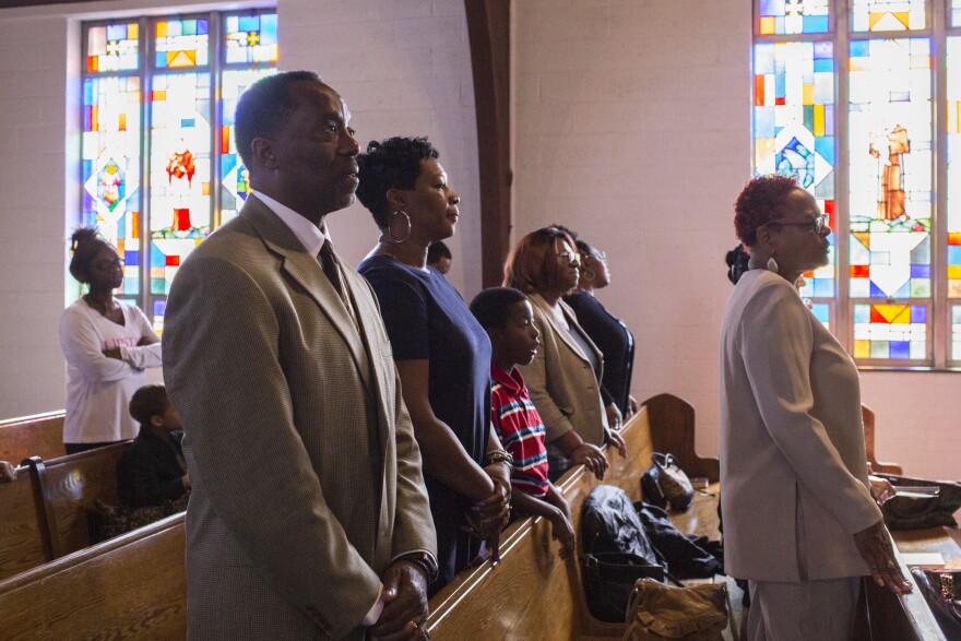 Ga'verri Jones-Collins attends a Sunday worship service with his grandparents, Charleston and Mary.