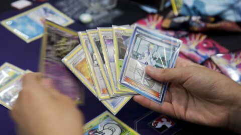 Competitor Jeffrey Chang from Washington state, reviews his hand, as he competes for a last chance qualifier spot in the Pokémon trading card game for the 2014 Pokémon World Championships in Washington, Friday, Aug. 15, 2014.