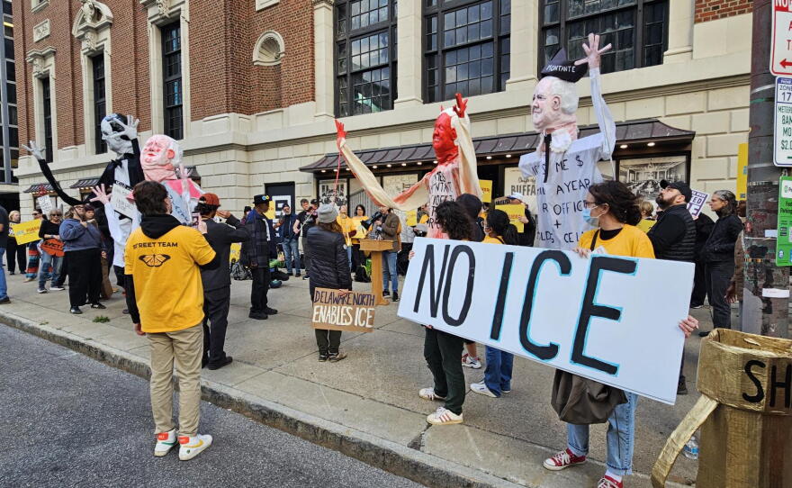 Protesters stand outside the Statler Building, calling for Carl Montante to end rental agreements with ICE
