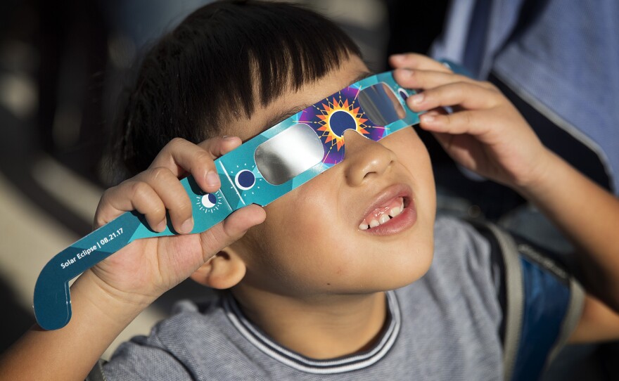 Stanley Liu, 6, looks toward the sun during the solar eclipse on Monday, August 21, 2017, at the Pacific Science Center on 2nd Ave., in Seattle. 